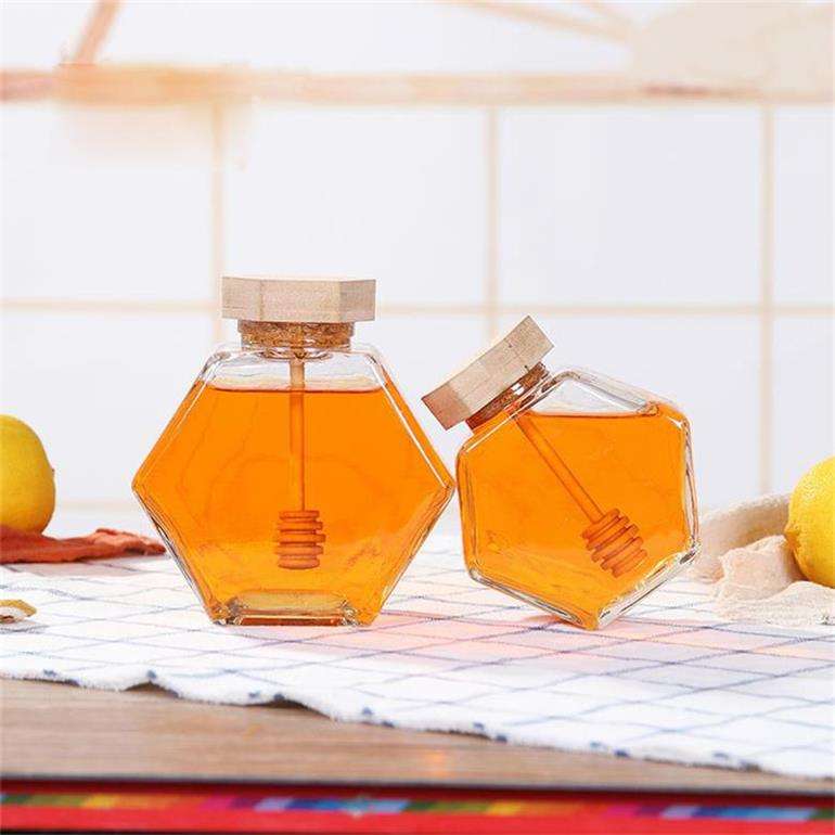 Wholesale label hexagonal fancy small empty pot can packaging bottle unique mini bee hexagon glass honey jar with wooden dipper